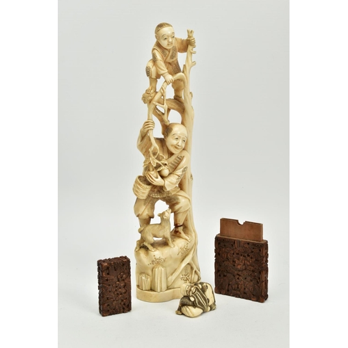 178 - A LATE 19TH CENTURY JAPANESE IVORY OKIMONO, carved as a child standing at the top of some branches w... 