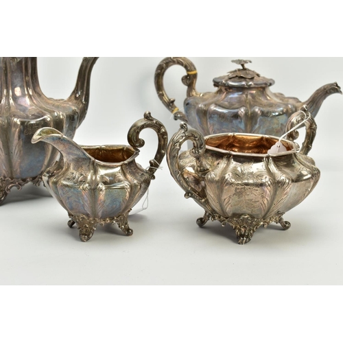 179 - A FOUR PIECE SILVER TEASET, to include an elaborate foliate engraved wavy body of melon shape, scrol... 