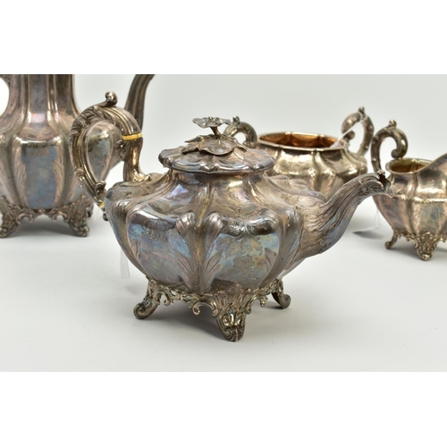 179 - A FOUR PIECE SILVER TEASET, to include an elaborate foliate engraved wavy body of melon shape, scrol... 