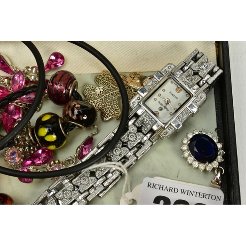 202 - A SELECTION OF COSTUME JEWELLERY, to include two white metal charm bracelets with charms, a pink cor... 