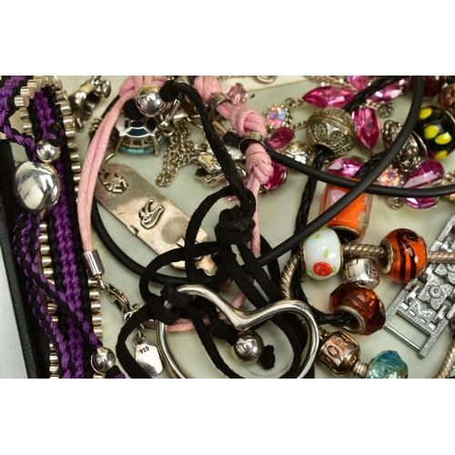 202 - A SELECTION OF COSTUME JEWELLERY, to include two white metal charm bracelets with charms, a pink cor... 