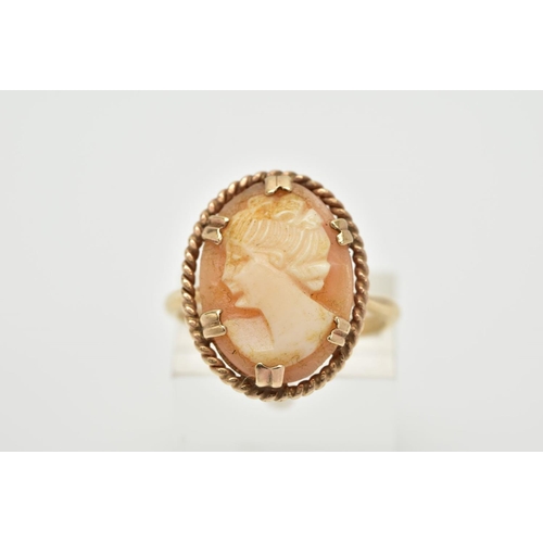 3 - A YELLOW METAL CAMEO RING, the claw set cameo of oval design, depicting a lady in profile, within a ... 