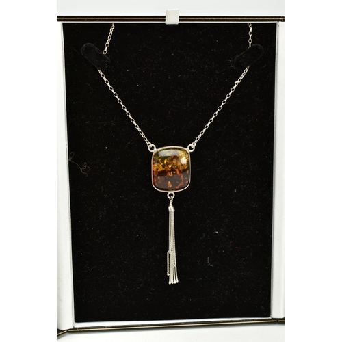 33 - A CASED WHITE METAL AMBER PENDANT NECKLACE, the fitted pendant of square form, set with a square cab... 