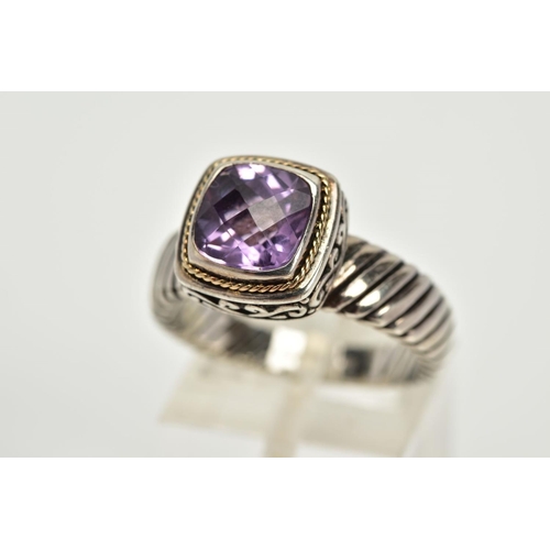 34 - A SILVER AMETHYST RING, designed with a cushion cut amethyst within a collet mount with a rope twist... 