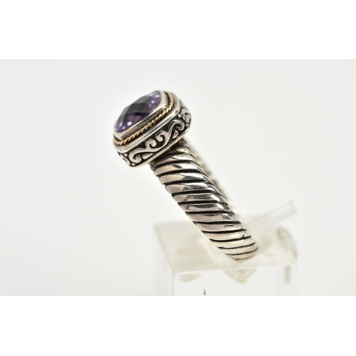 34 - A SILVER AMETHYST RING, designed with a cushion cut amethyst within a collet mount with a rope twist... 