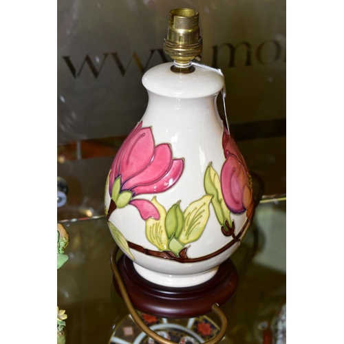 350 - A MOORCROFT POTTERY TABLE LAMP WITH PINK MAGNILIA ON A CREAM GROUND, mounted on a wooden base, heigh... 