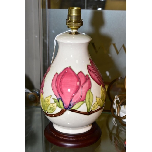 350 - A MOORCROFT POTTERY TABLE LAMP WITH PINK MAGNILIA ON A CREAM GROUND, mounted on a wooden base, heigh... 