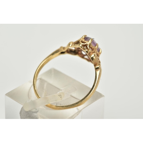 39 - A 9CT GOLD AMETHYST RING, designed with a claw set, oval cut amethyst within an open work gallery, b... 