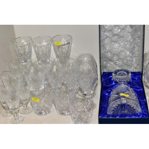 411 - A QUANTITY OF GLASSWARE, including three square decanters, a conical shaped vase, a water jug, a lar... 