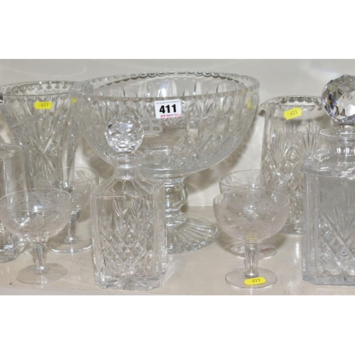 411 - A QUANTITY OF GLASSWARE, including three square decanters, a conical shaped vase, a water jug, a lar... 