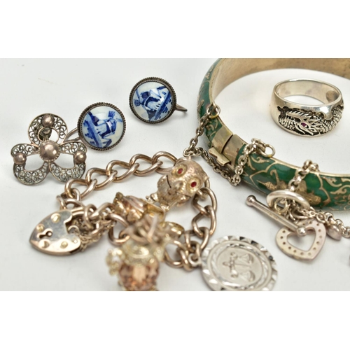 44 - A SELECTION OF JEWELLERY, to include a silver charm bracelet, suspending four white metal charms suc... 