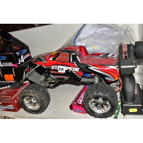 445 - A REMOTE CONTROL TRAXXAS STAMPEDE WHEELSPIN TRUCK AND A QUANTITY OF ACCESSORIES, SPARE PARTS AND TOO... 