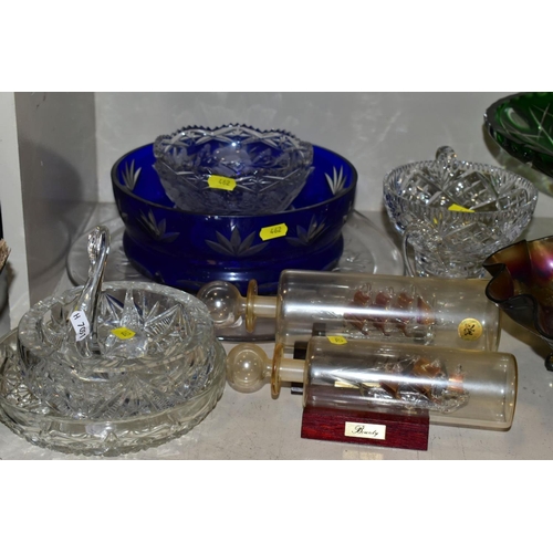 462 - A QUANTITY OF GLASSWARE, to include four decanters, a pair of candle holders with glass shades, jars... 