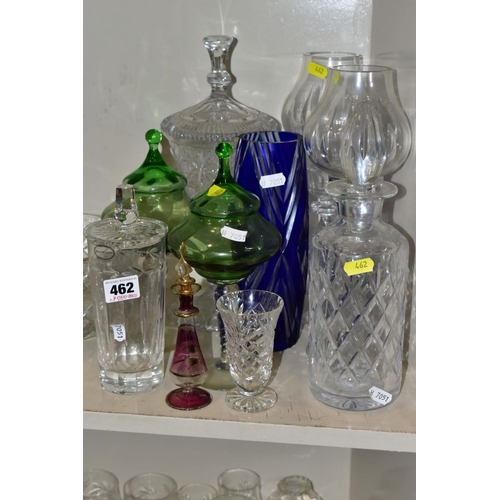 462 - A QUANTITY OF GLASSWARE, to include four decanters, a pair of candle holders with glass shades, jars... 