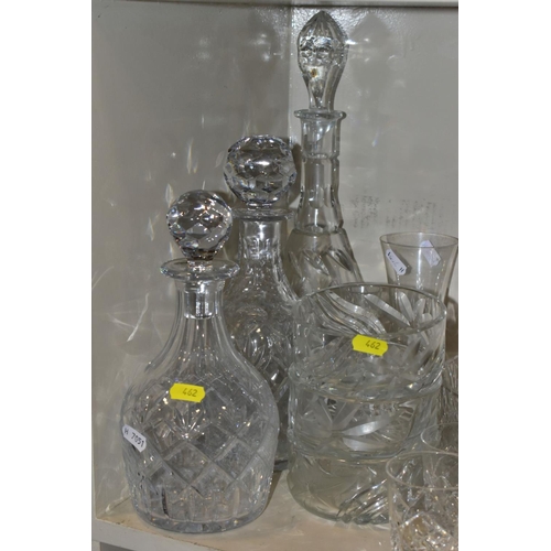 462 - A QUANTITY OF GLASSWARE, to include four decanters, a pair of candle holders with glass shades, jars... 