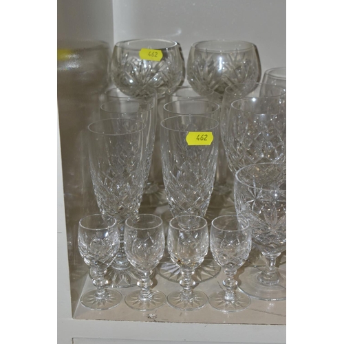 462 - A QUANTITY OF GLASSWARE, to include four decanters, a pair of candle holders with glass shades, jars... 