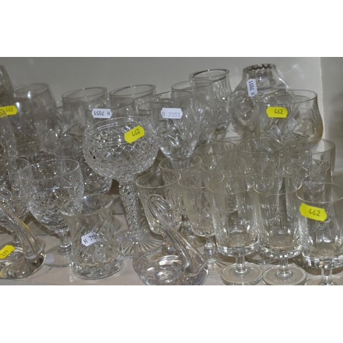 462 - A QUANTITY OF GLASSWARE, to include four decanters, a pair of candle holders with glass shades, jars... 