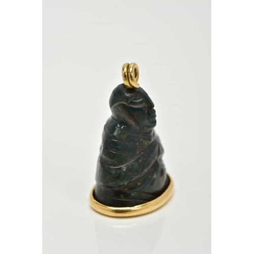 5 - AN 18CT GOLD MOUNTED CARVED BLOODSTONE PENDANT, the carved bloodstone in the form of a buddha, mount... 