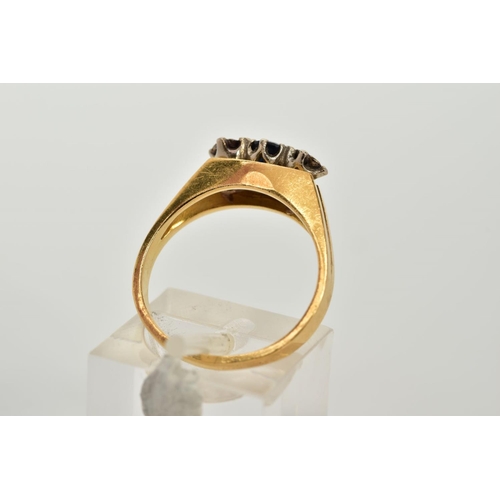 51 - A YELLOW METAL THREE STONE SAPPHIRE AND DIAMOND RING, the raised designed set with a central circula... 