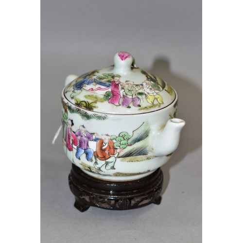 514 - A 20TH CENTURY CHINESE PORCELAIN FAMILLE ROSE TEAPOT, of circular form, with peach finial, decorated... 