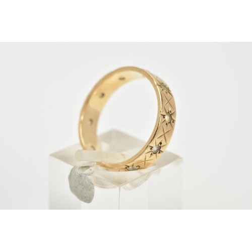 52 - A 9CT GOLD FULL ETERNITY RING, the band with an engraved star detail, set with circular cut colourle... 