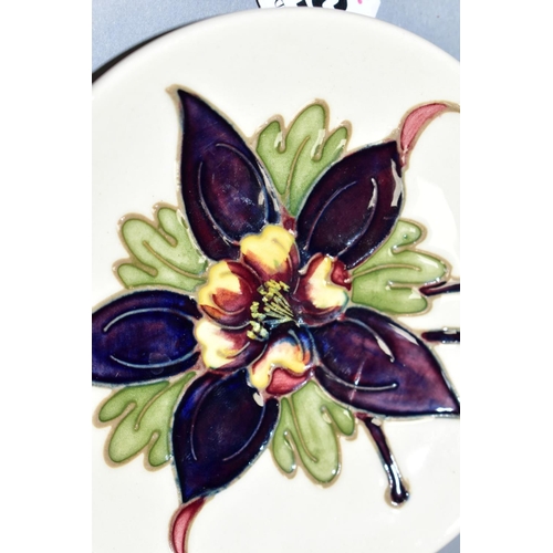 522 - A MOORCROFT POTTERY CIRCULAR PIN DISH, 'Columbine' pattern on cream ground, impressed marks to base,... 