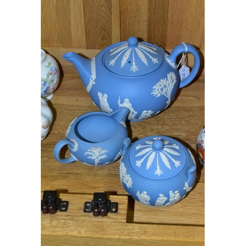 526 - A WEDGWOOD BLUE JASPERWARE THREE PIECE TEA SERVICE, comprising teapot, covered sugar bowl and milk j... 