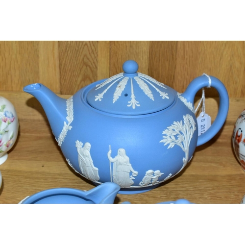 526 - A WEDGWOOD BLUE JASPERWARE THREE PIECE TEA SERVICE, comprising teapot, covered sugar bowl and milk j... 