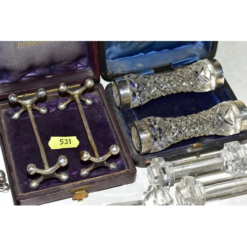 531 - A TRAY OF VARIOUS KNIFE RESTS, to include cased pair of silver rests, and a cased pair of silver rim... 