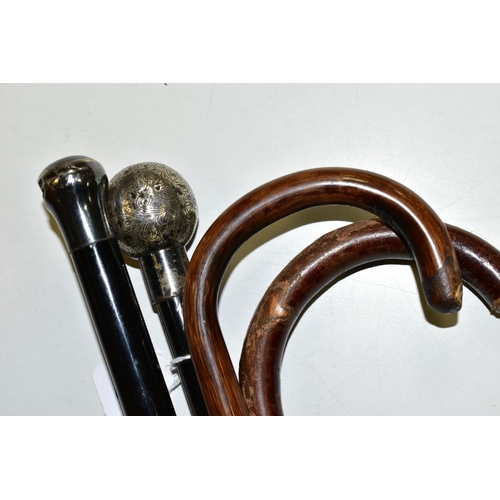 533 - TWO SILVER TOPPED WALKING CANES, (one with dent), length 90cm, together with two walking sticks, one... 