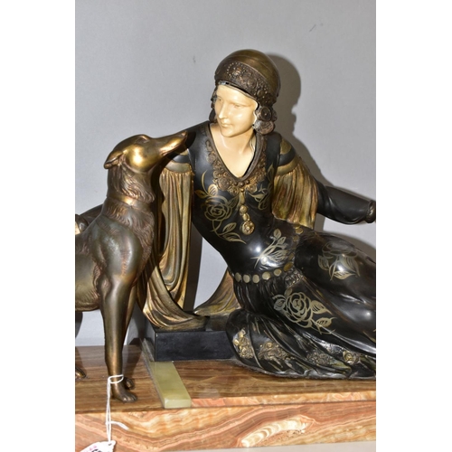 557 - AFTER MENNEVILLE, an art deco patinated spelter and ivorine model of a seated lady with seated dog, ... 