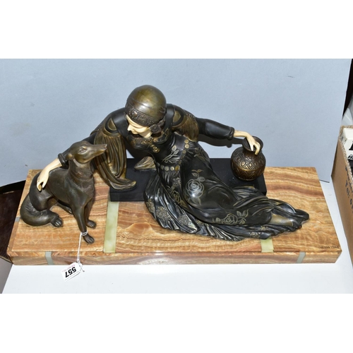 557 - AFTER MENNEVILLE, an art deco patinated spelter and ivorine model of a seated lady with seated dog, ... 