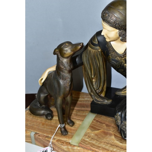 557 - AFTER MENNEVILLE, an art deco patinated spelter and ivorine model of a seated lady with seated dog, ... 