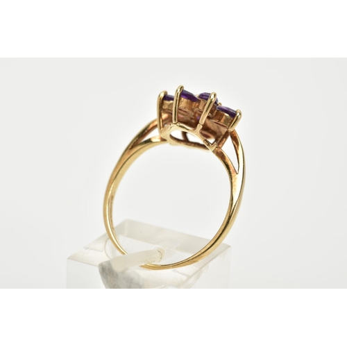 62 - A 9CT GOLD AMETHYST AND DIAMOND RING, of a spray design set with six marquise cut amethyst stones, w... 