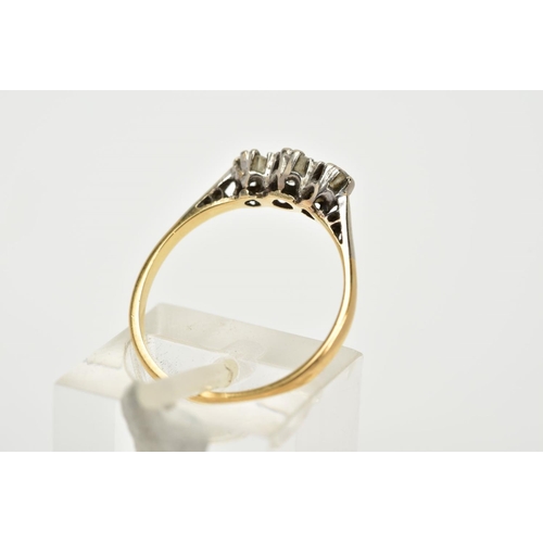 63 - A THREE STONE DIAMOND RING, the yellow metal ring, set with three graduated round brilliant cut diam... 