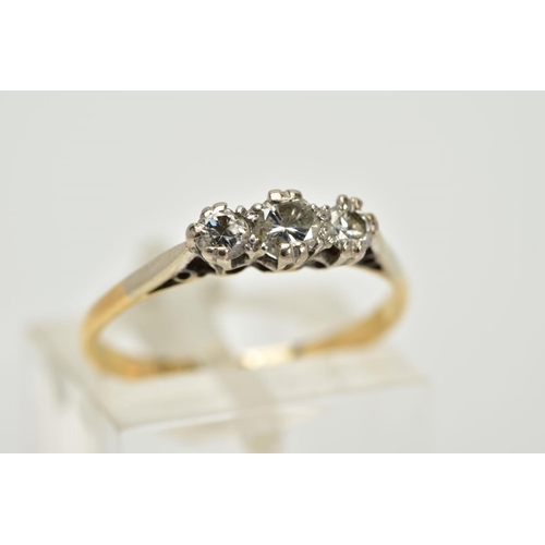 63 - A THREE STONE DIAMOND RING, the yellow metal ring, set with three graduated round brilliant cut diam... 