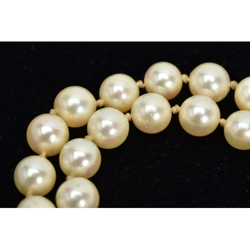 71 - A CULTURED PEARL NECKLACE, each circular pearl measuring approximately 7.0mm, on a white cord fitted... 