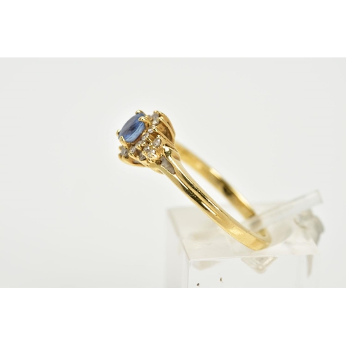 74 - AN 18CT GOLD SAPPHIRE AND DIAMOND CLUSTER RING, designed with a central oval cut blue sapphire withi... 