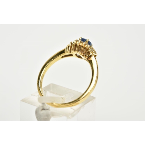 74 - AN 18CT GOLD SAPPHIRE AND DIAMOND CLUSTER RING, designed with a central oval cut blue sapphire withi... 