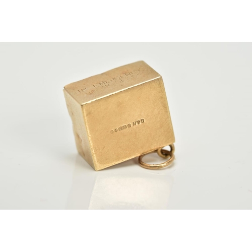 8 - A 9CT GOLD CASED TEN SHILLING NOTE CHARM, the folded note within a plain polished square case and gl... 