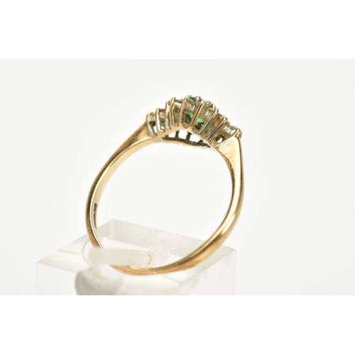 87 - A 9CT GOLD EMERALD AND DIAMOND CLUSTER RING, designed with a central oval cut emerald, within a roun... 