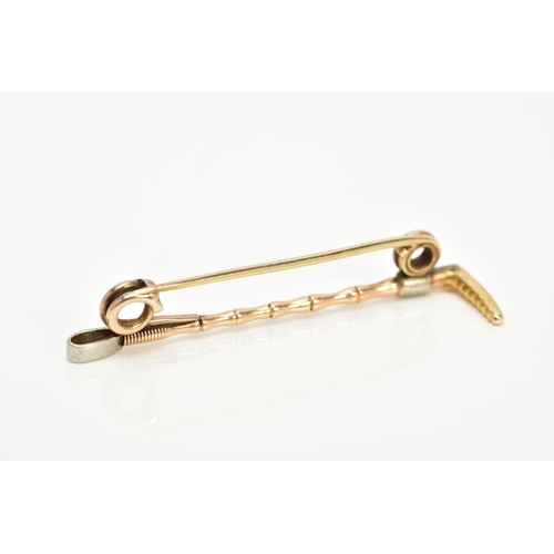 88 - A YELLOW METAL BAR BROOCH, in the form of a riding crop, length 50mm, approximate gross weight 4.3 g... 