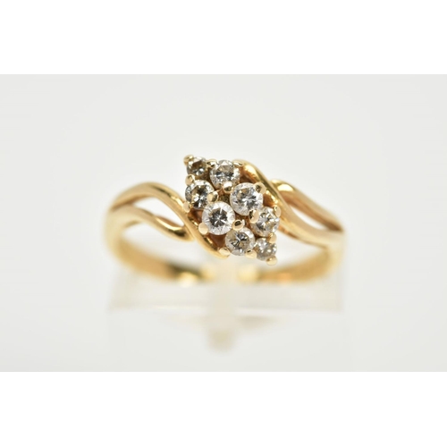 91 - A YELLOW METAL DIAMOND RING, the asymmetrical lozenge shape set with eight round brilliant cut diamo... 