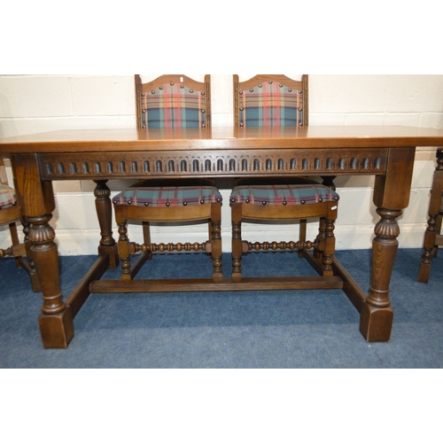 1260 - AN OLD CHARM OAK REFECTORY DINING TABLE, with a carved frieze, on turned legs united by a H stretche... 