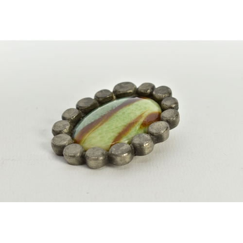 143 - A BENT LARSEN DESIGNS PEWTER PENDANT, of an oval form, set with an imitation agate cabochon of green... 