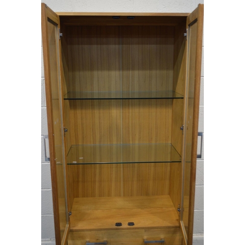 1341 - A MODERN GOLDEN OAK GLAZED TWO DOOR DISPLAY CABINET, two glass shelves above three drawers, width 90... 