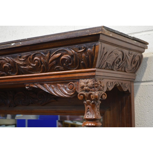 1349 - AN EARLY 20TH CENTURY WALNUT MIRROR BACK SIDEBOARD, foliate decoration, overhanging top supported by... 