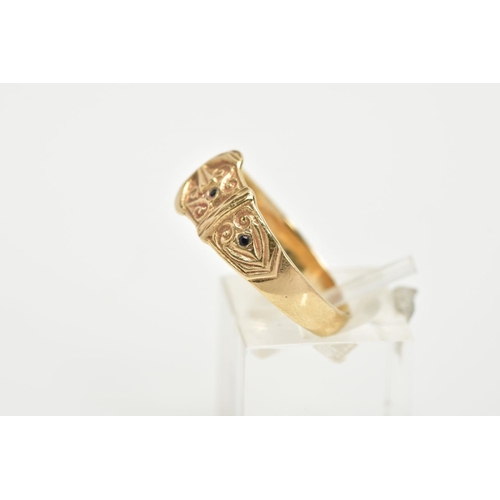 6 - A 9CT GOLD BUCKLE RING, with scroll engraved detailing set with two circular cut sapphires, hallmark... 