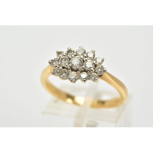 63 - AN 18CT GOLD DIAMOND CLUSTER RING, the cluster of an oval form, set with fifteen graduated round bri... 