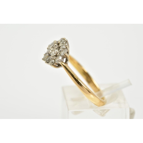 63 - AN 18CT GOLD DIAMOND CLUSTER RING, the cluster of an oval form, set with fifteen graduated round bri... 